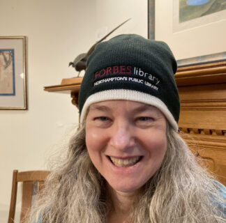 Molly wearing a Forbes Library Beanie