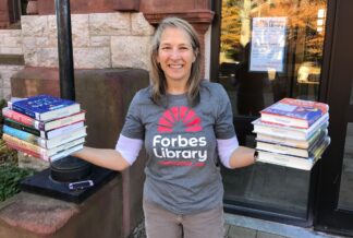 A librarian wearing a Forbes Library t-shirt.
