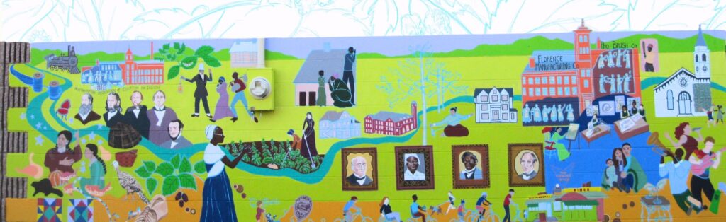 Photography of the mural "Action: A History of Florence" illustrating scenes and people from Florence's history against a bright green background with the Mill River running through the mural.