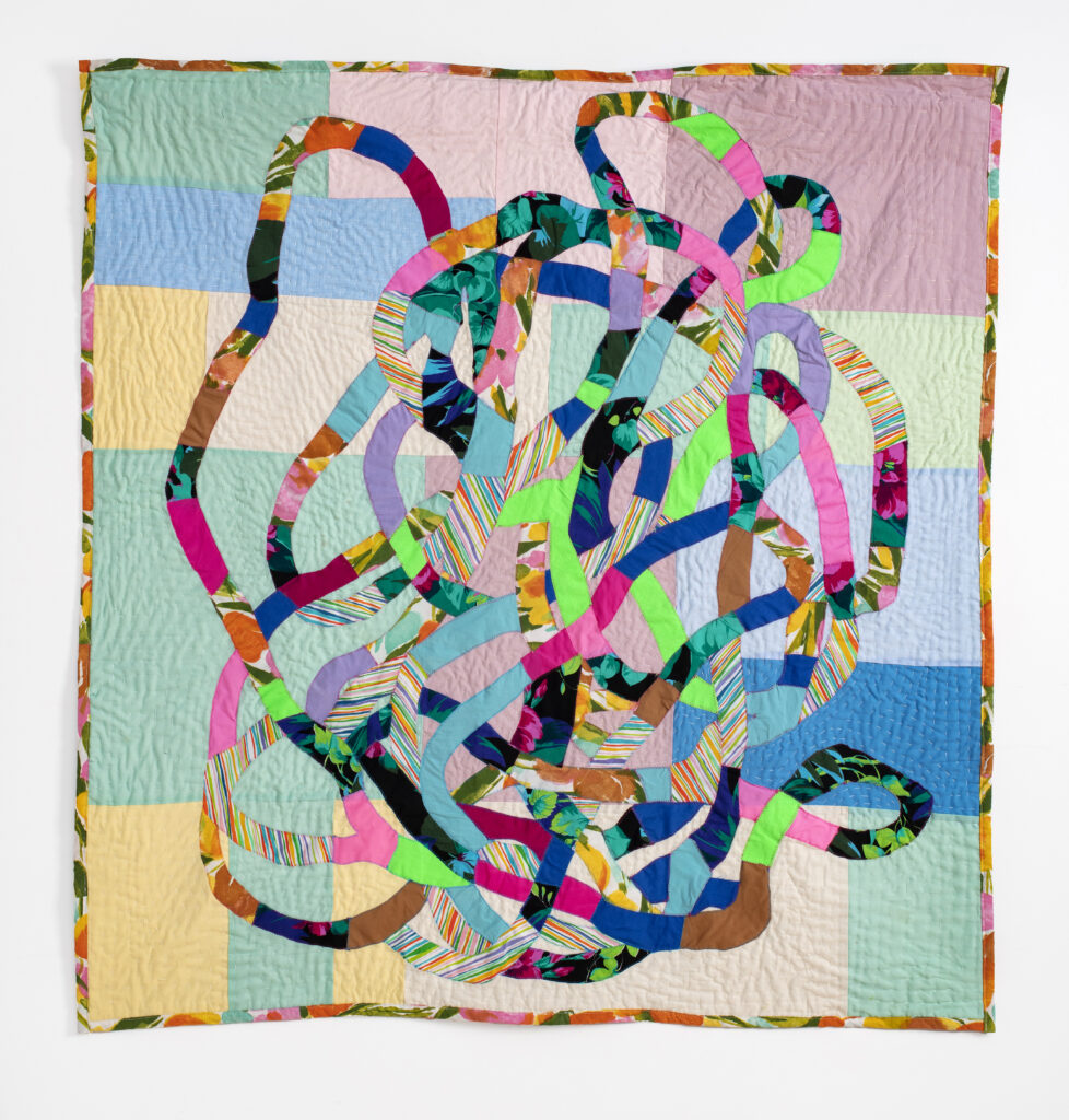 Patchwork quilt with appliqued pieces resembling a large tangled knot. Handquilted. 